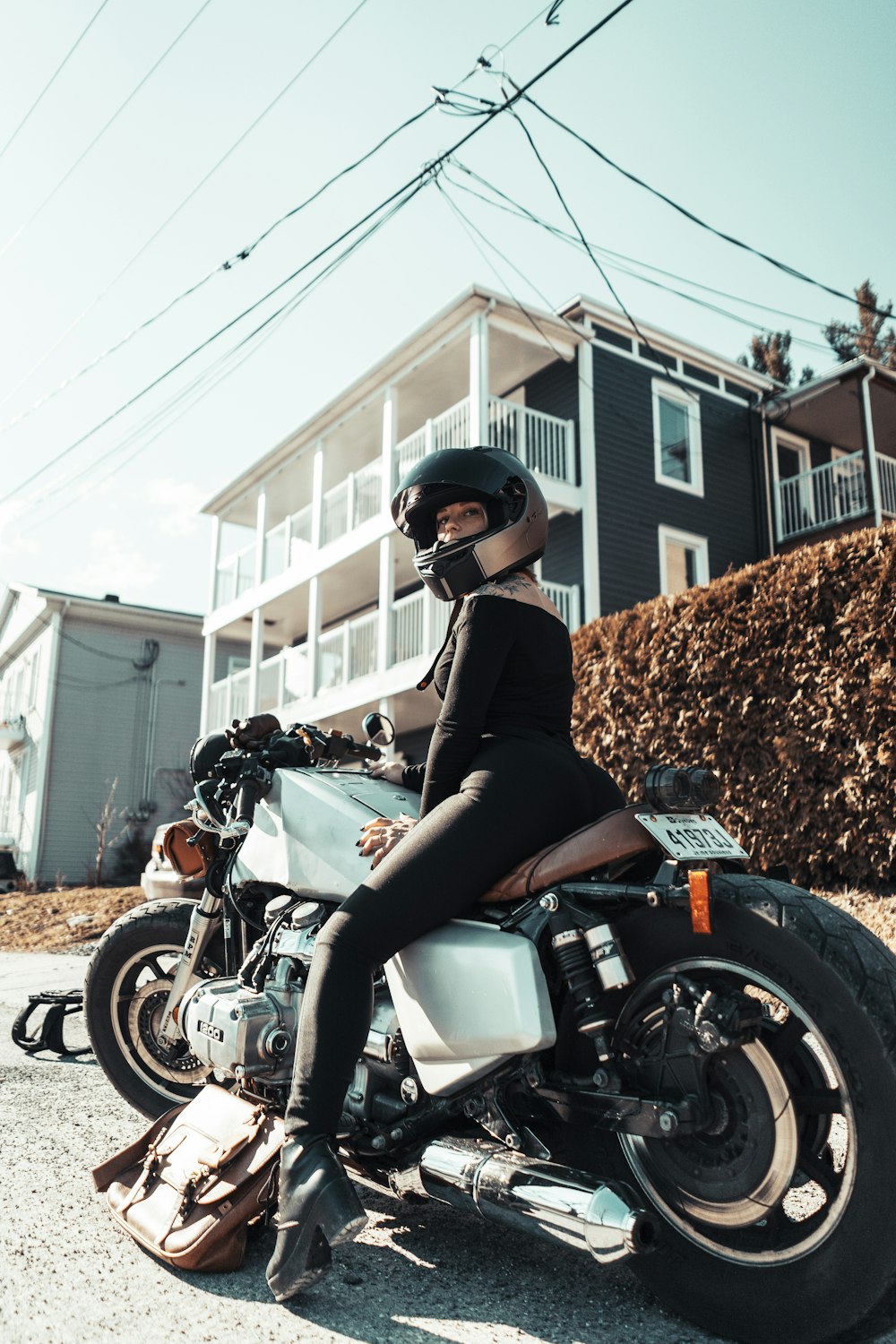 woman in black jacket riding black motorcycle during daytime