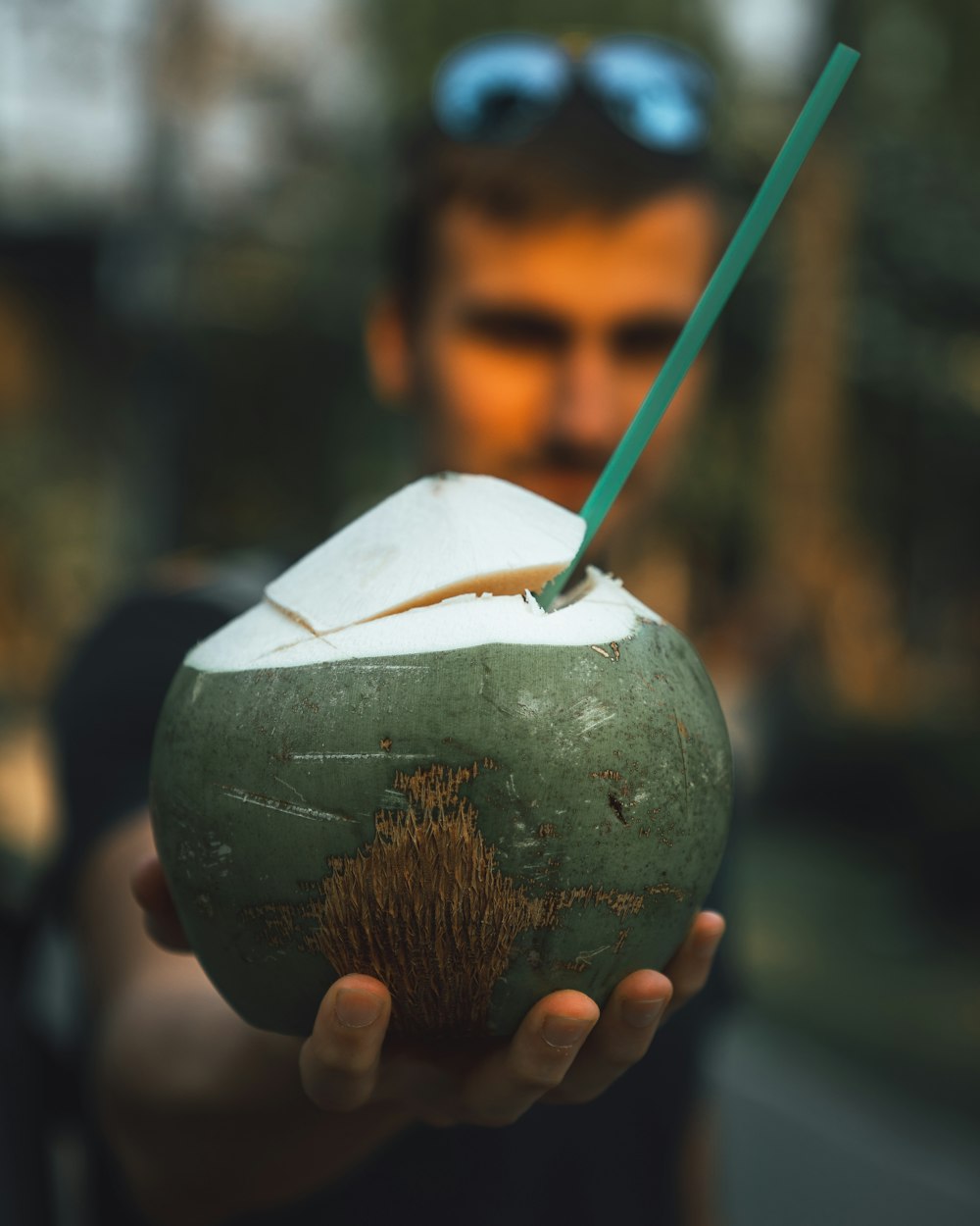 person holding green and brown ball