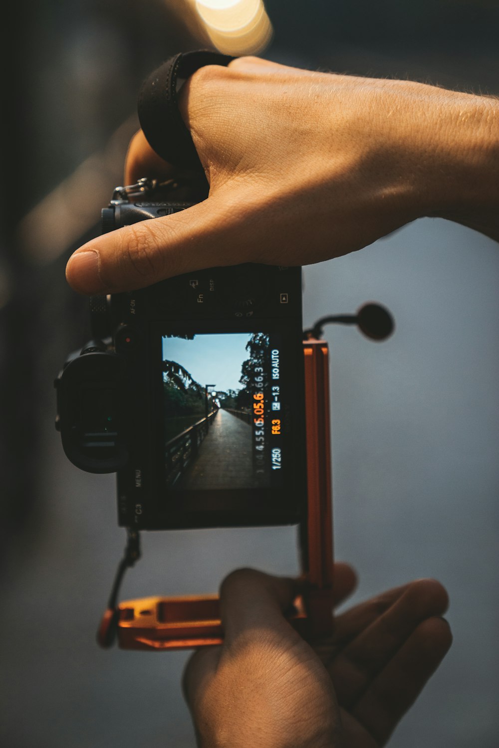 person holding black smartphone taking photo of a bridge