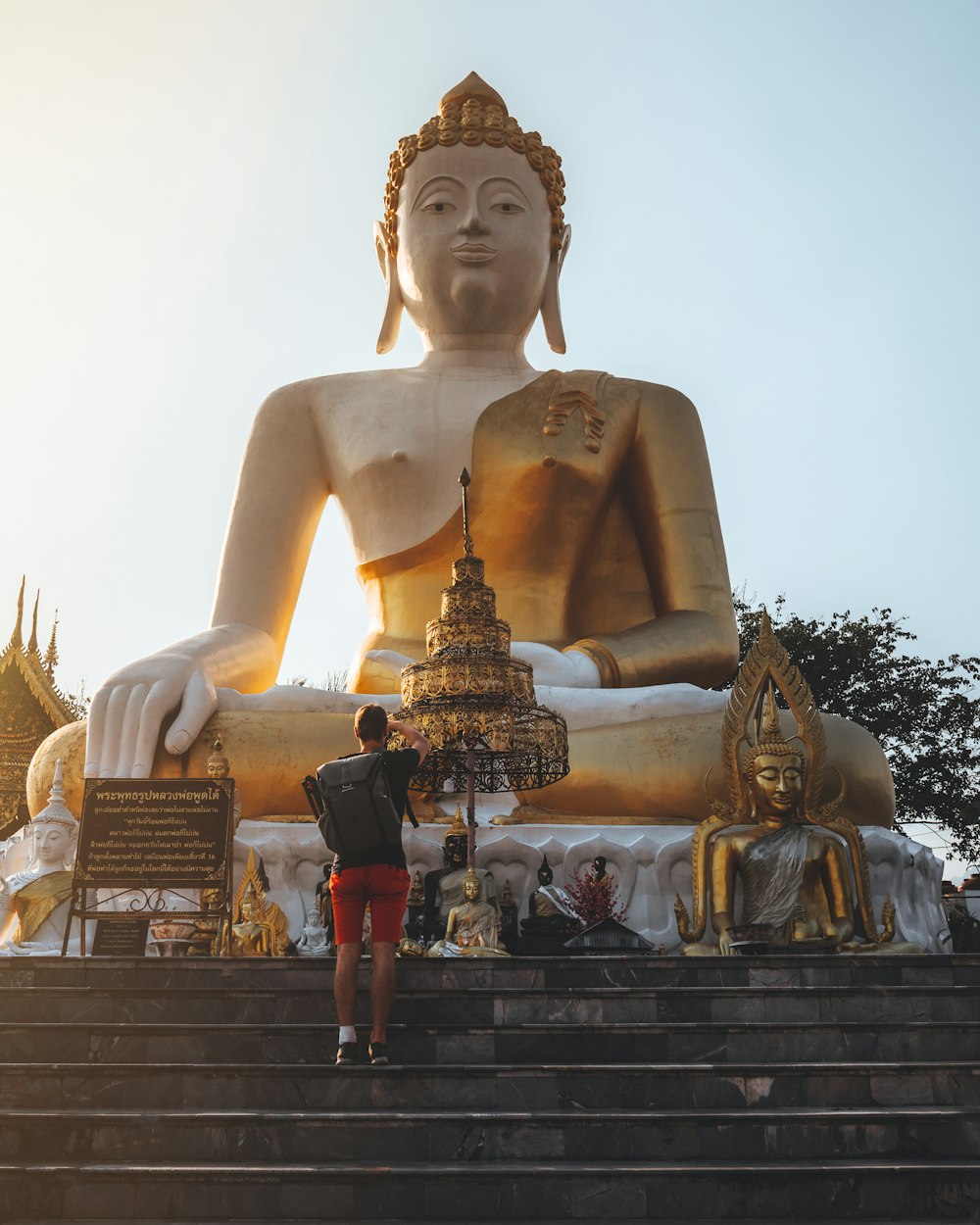 gold buddha statue under white sky during daytime