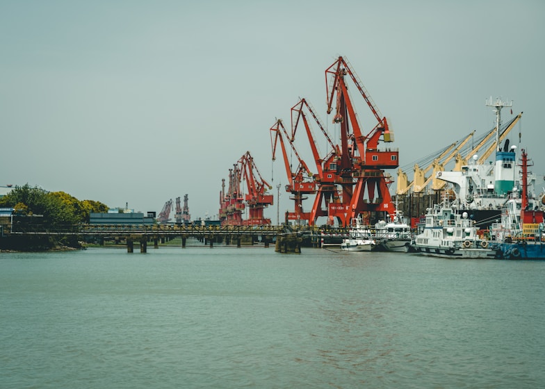 red and white crane on dock during daytime
