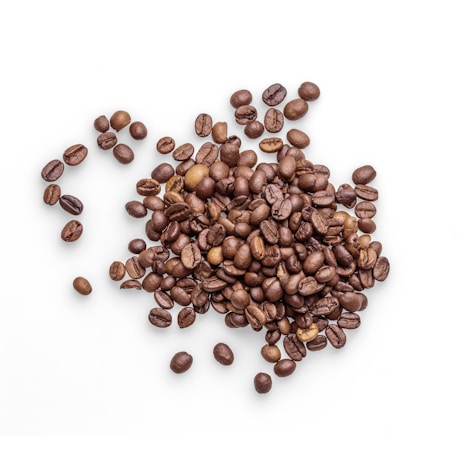 A pile of roasted coffee beans scattered across a white surface, showcasing a variety of rich brown tones and glossy textures.