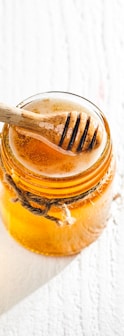 clear glass jar with brown liquid inside