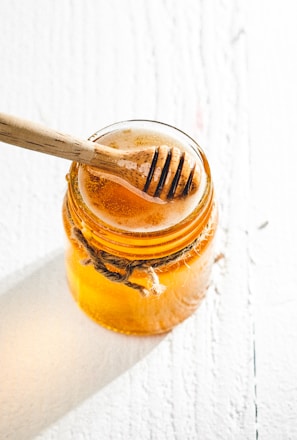 clear glass jar with brown liquid inside