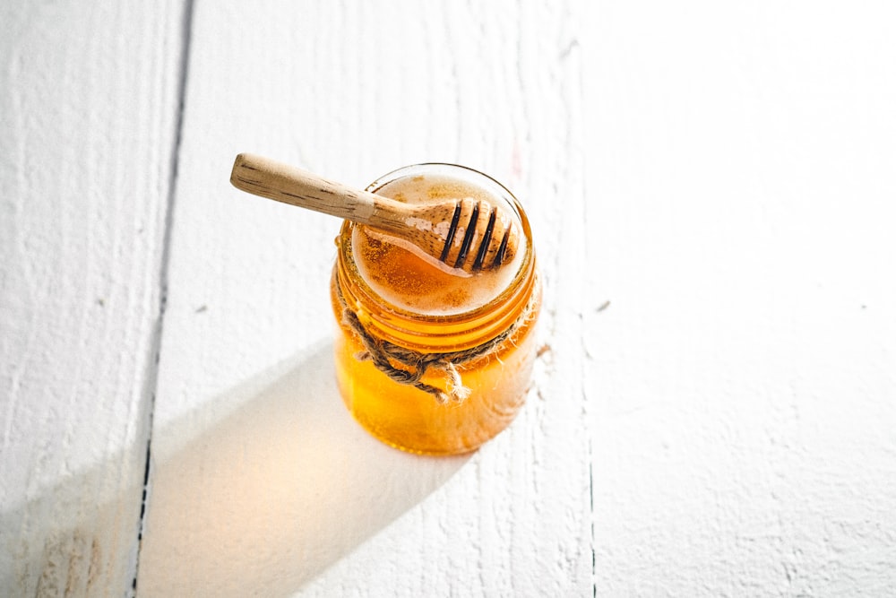 clear glass jar with brown liquid inside