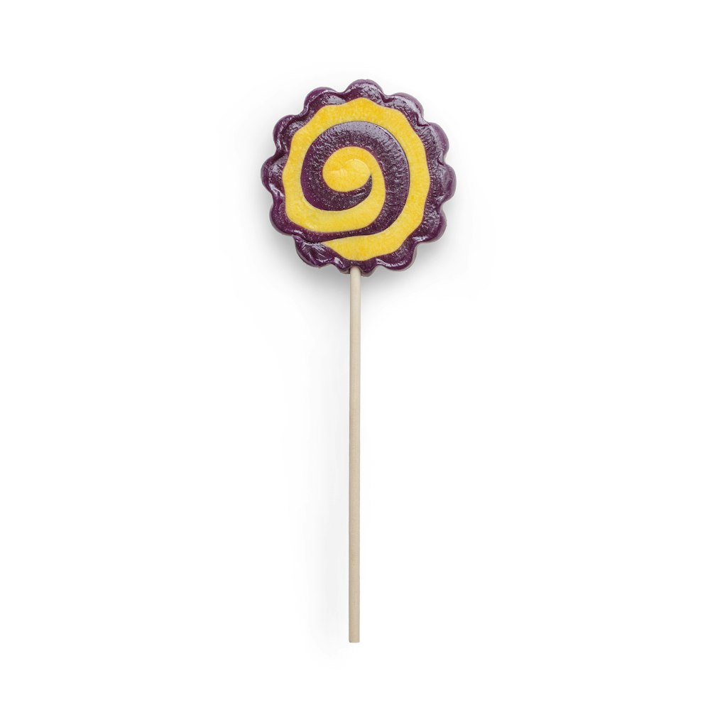 purple and yellow lollipop with white background