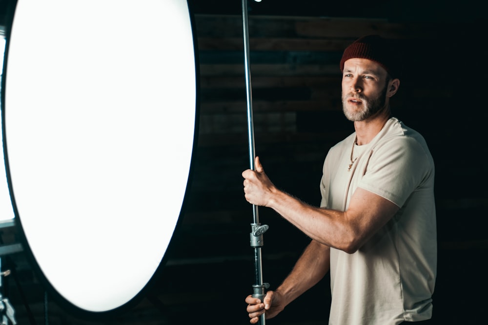 man in white polo shirt holding black and silver hookah