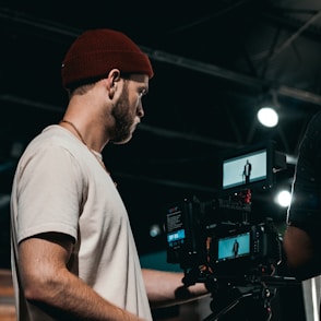 man in white crew neck t-shirt wearing orange knit cap