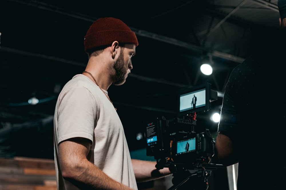 man in white crew neck t-shirt wearing orange knit cap