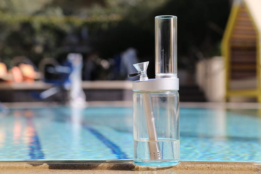 clear glass bottle on blue table