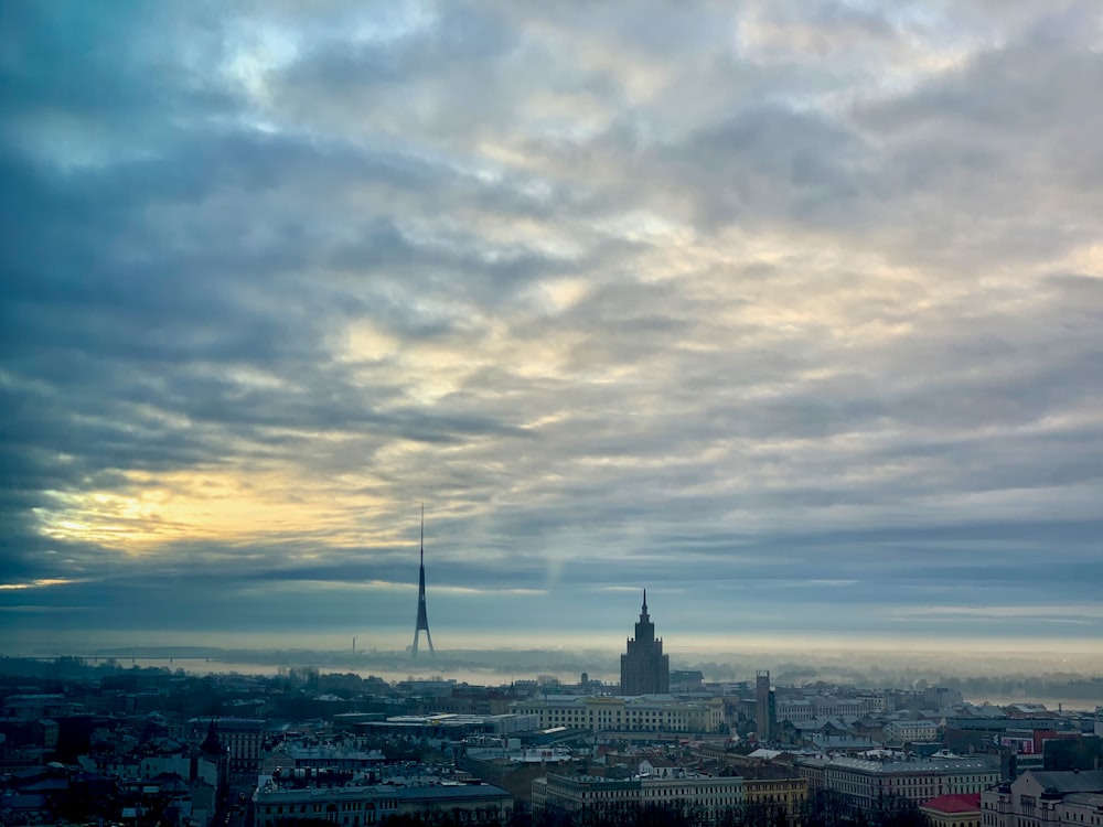 city skyline under cloudy sky during daytime