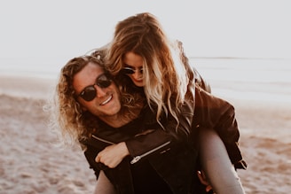 woman in black leather jacket wearing black sunglasses