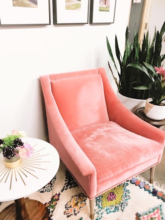 pink sofa chair beside white round table