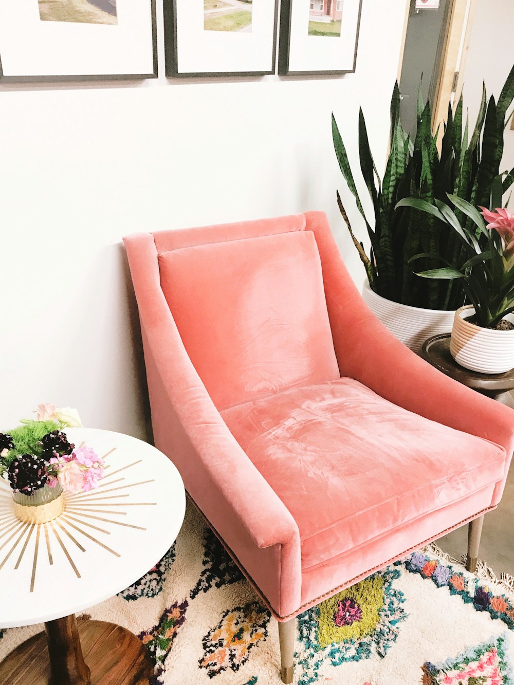 pink sofa chair beside white round table