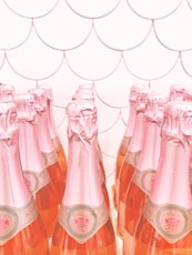 pink glass bottles on brown wooden table