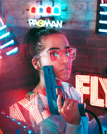 A joyful gamer holding the light gun, smiling as they aim at the screen with classic pixelated game graphics.