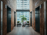 brown wooden door near green potted plant