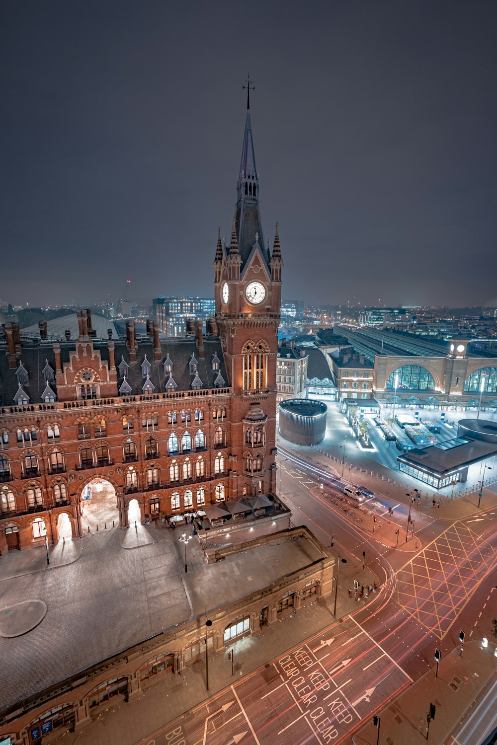 man in white shirt standing on top of building during night time