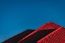 red and black building under blue sky