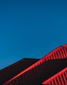 red and black building under blue sky