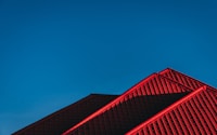 red and black building under blue sky