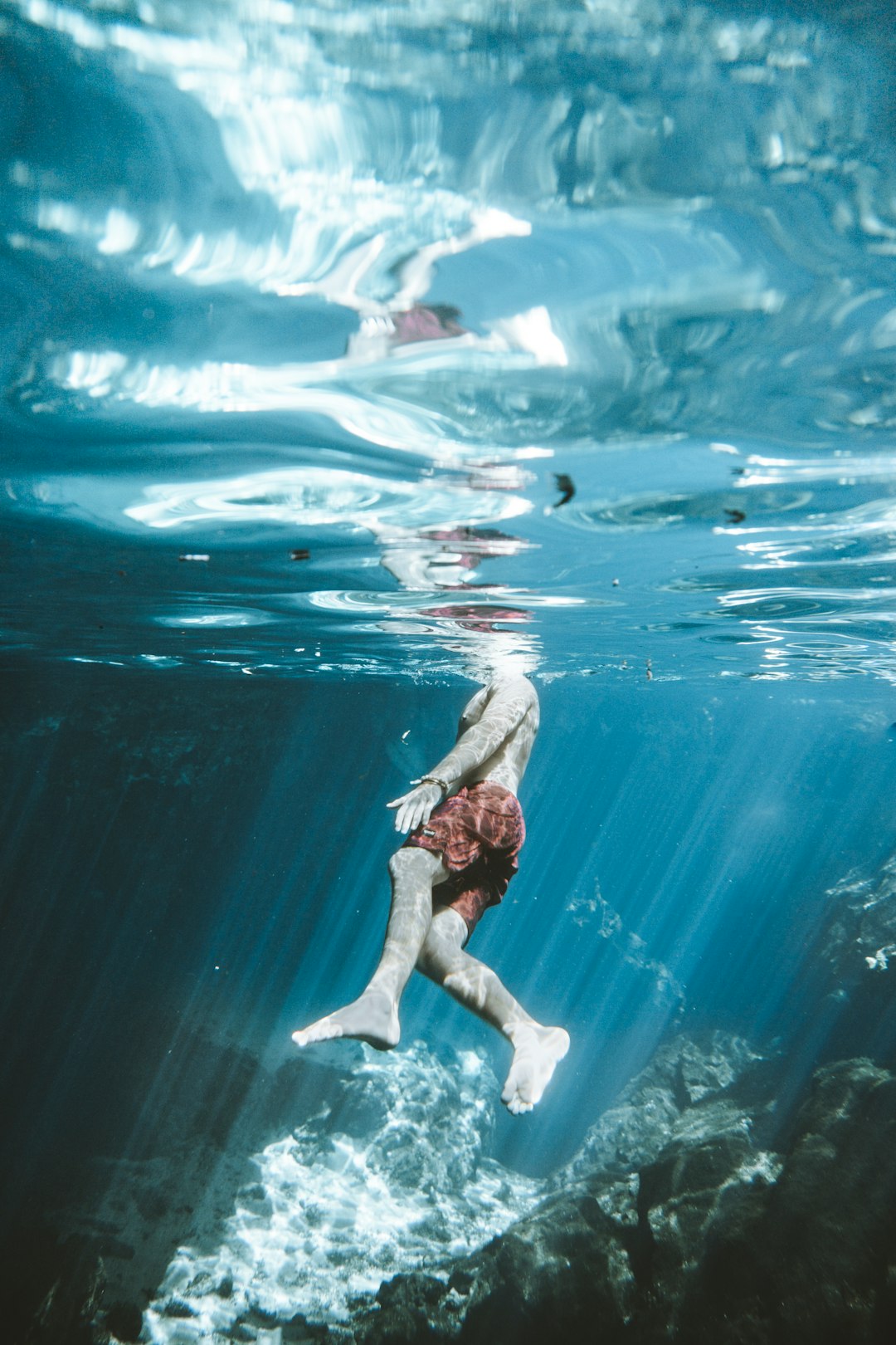 woman in brown bikini swimming in water