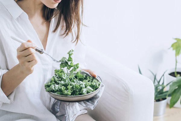 Woman enjoying a healthy vegetarian salad bowl