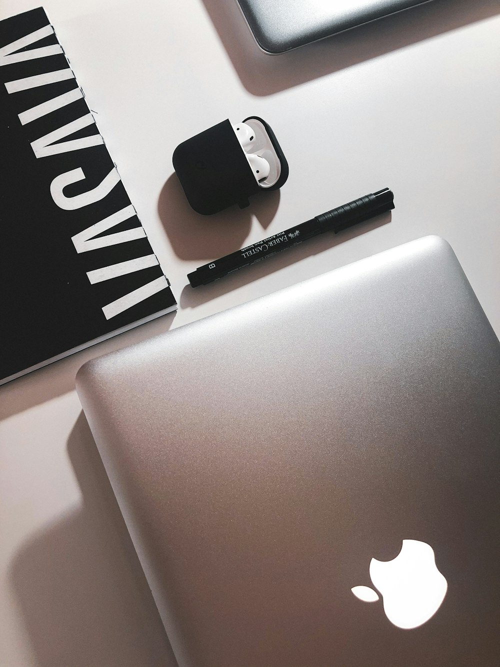 black and silver click pen beside silver macbook