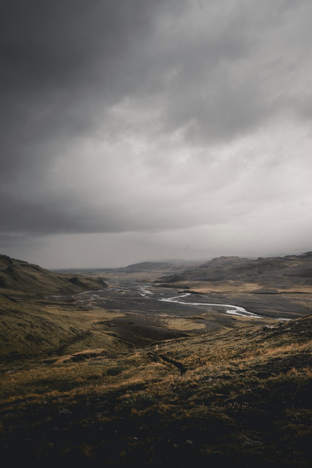 brown and green mountains under white clouds