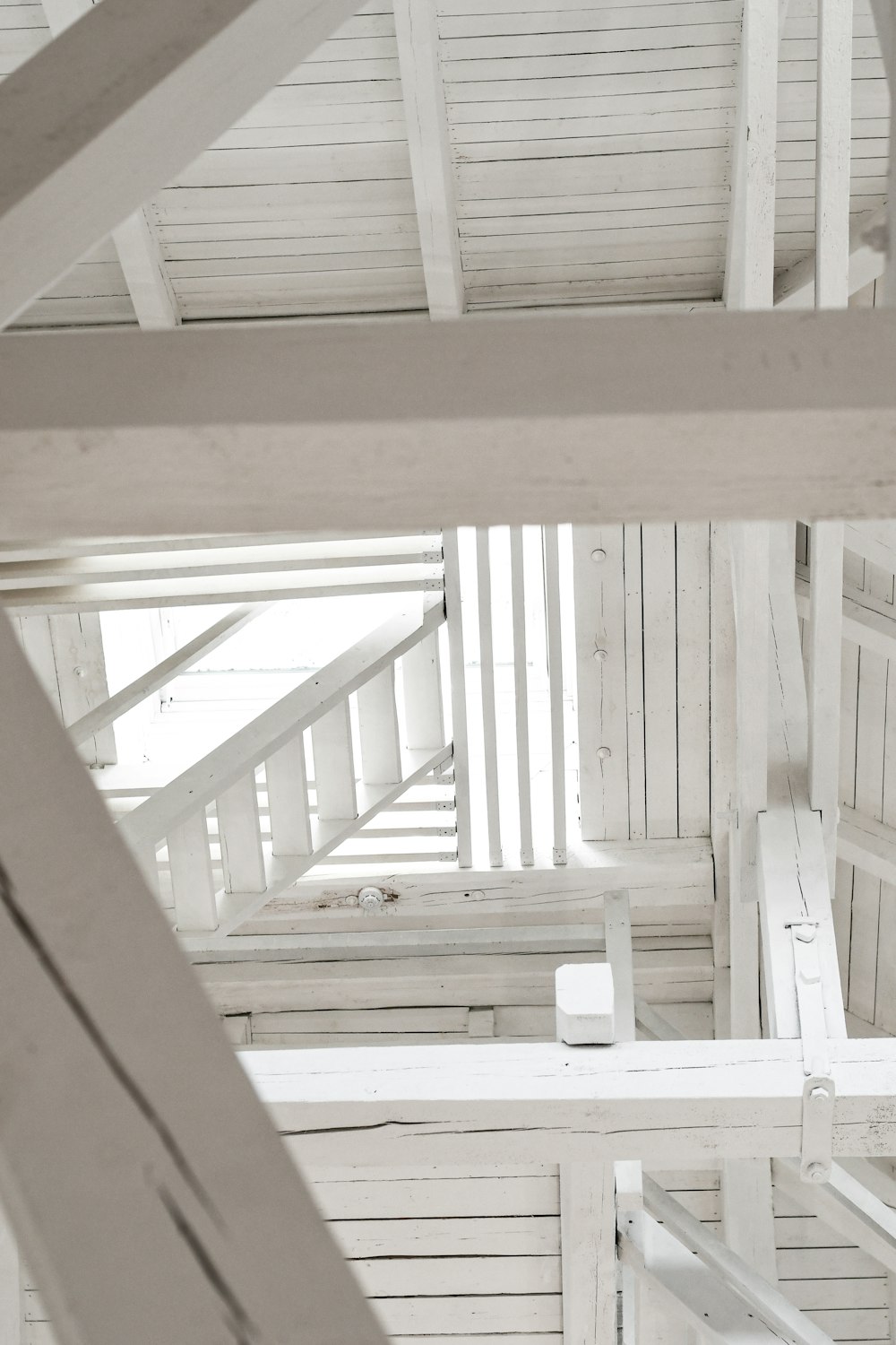 white wooden staircase with white wooden railings