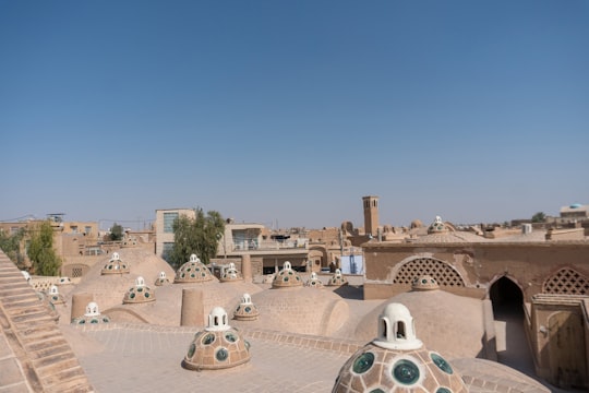 people walking on park during daytime in Sultan Amir Ahmad Bathhouse Iran