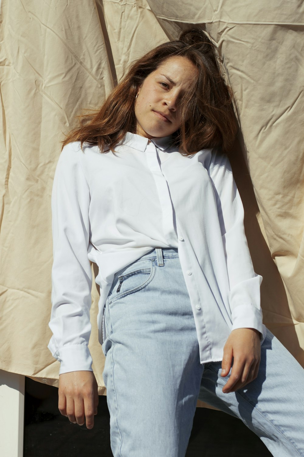 woman in white long sleeve shirt and blue denim jeans