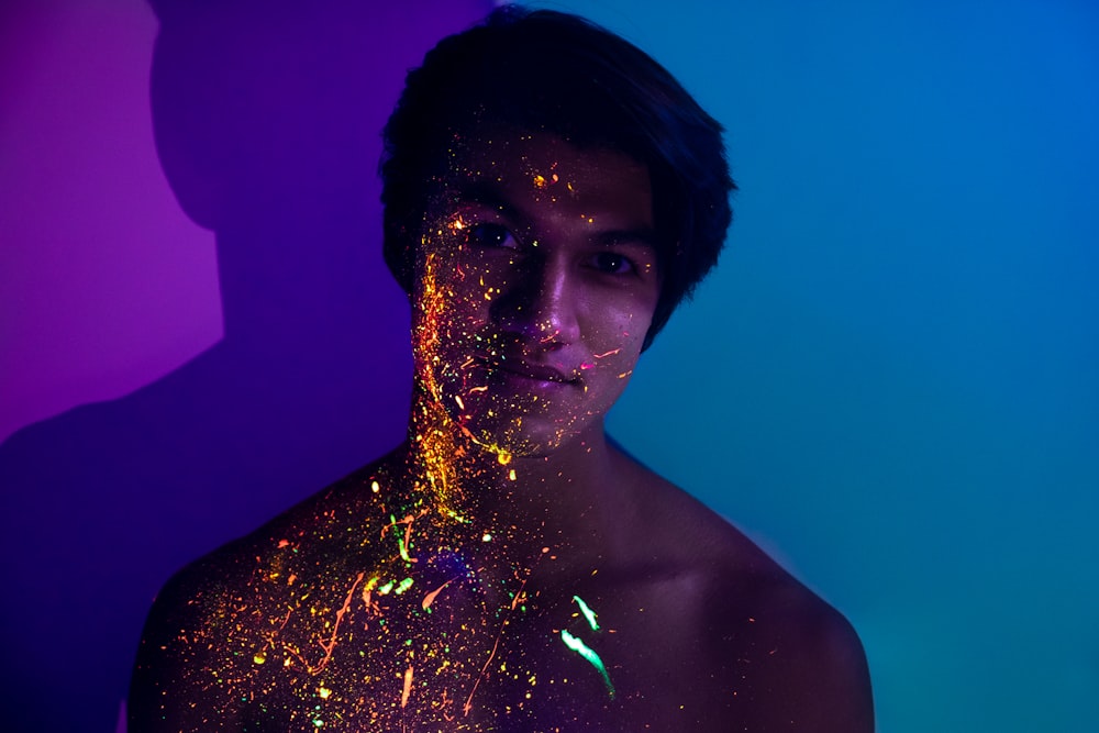 topless man with blue and purple lights on his body