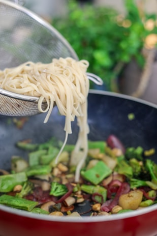 white pasta on stainless steel strainer