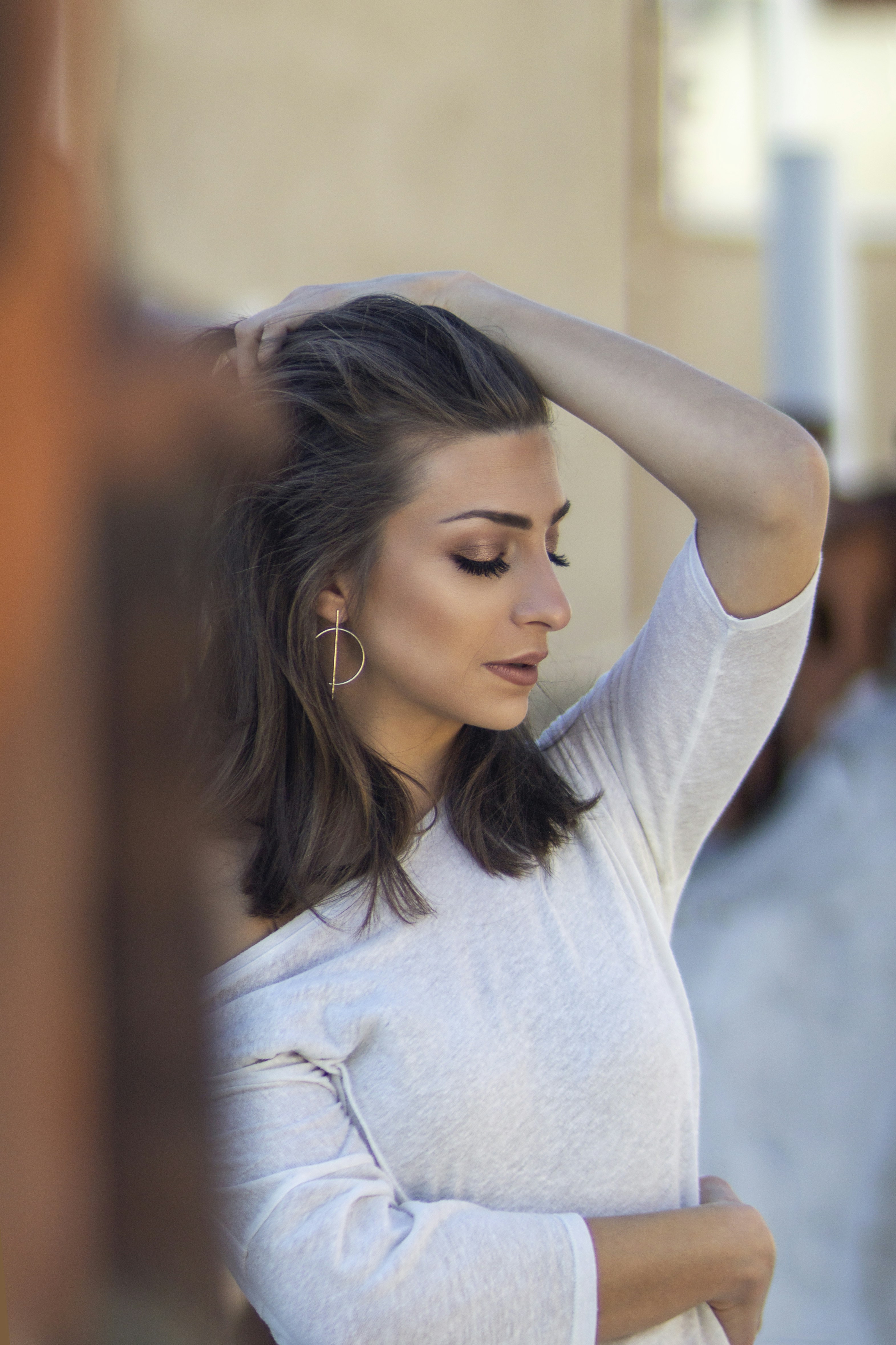 woman in gray crew neck t-shirt wearing silver hoop earrings