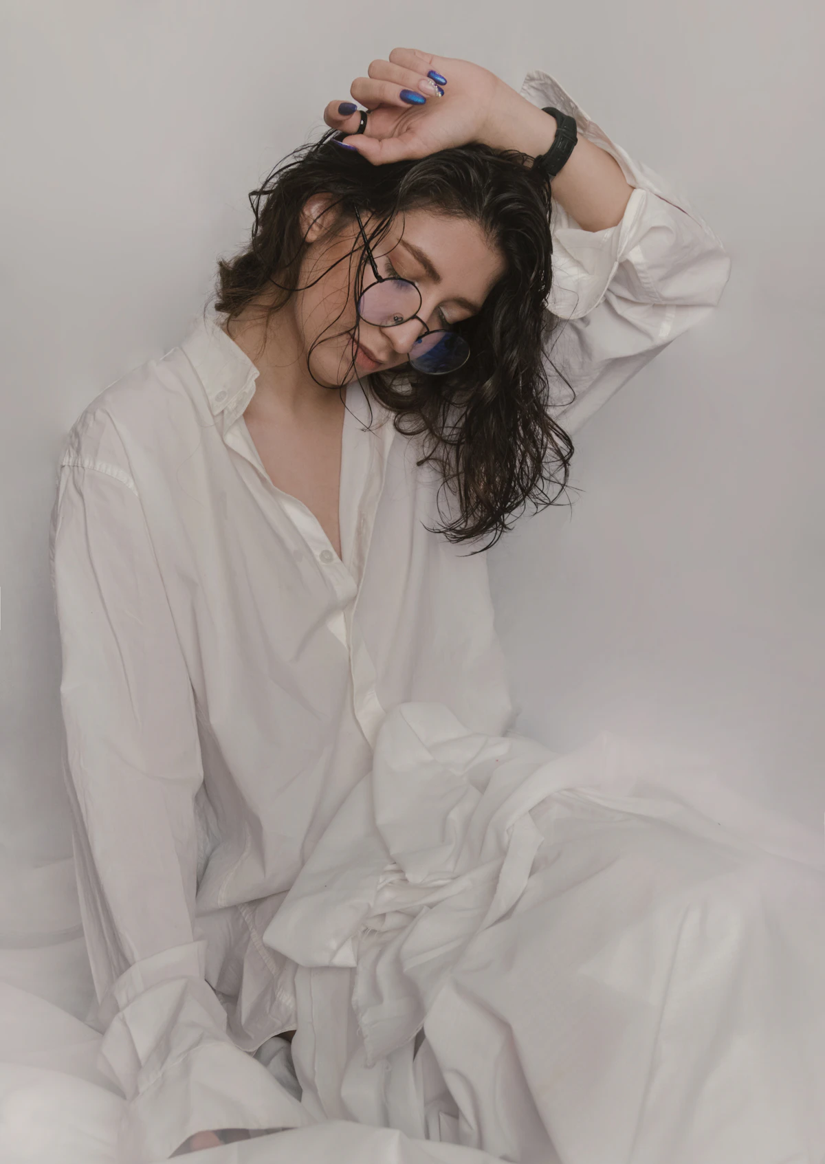 A woman styling a white shirt with tailored trousers