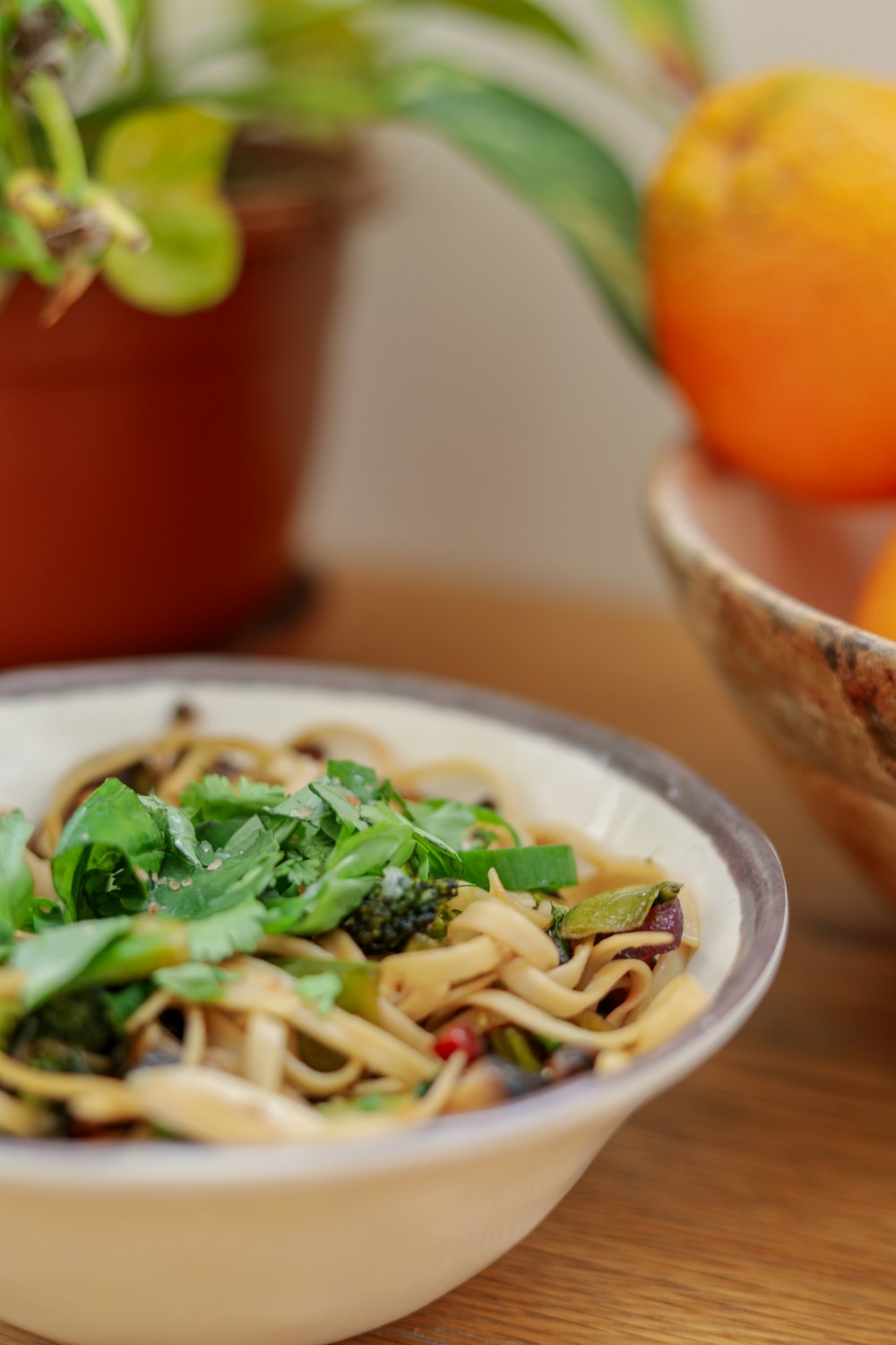 pasta with green leaf vegetable on white ceramic plate