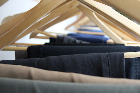 Image showing sturdy professional work pants hanging neatly in a factory locker room.