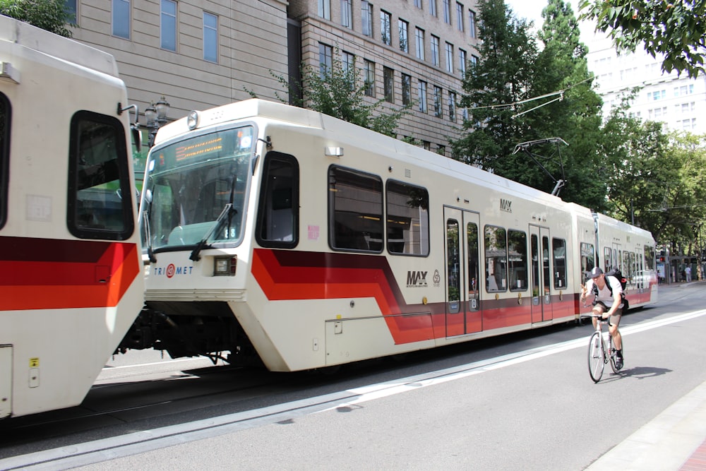 white red and yellow train on rail road during daytime