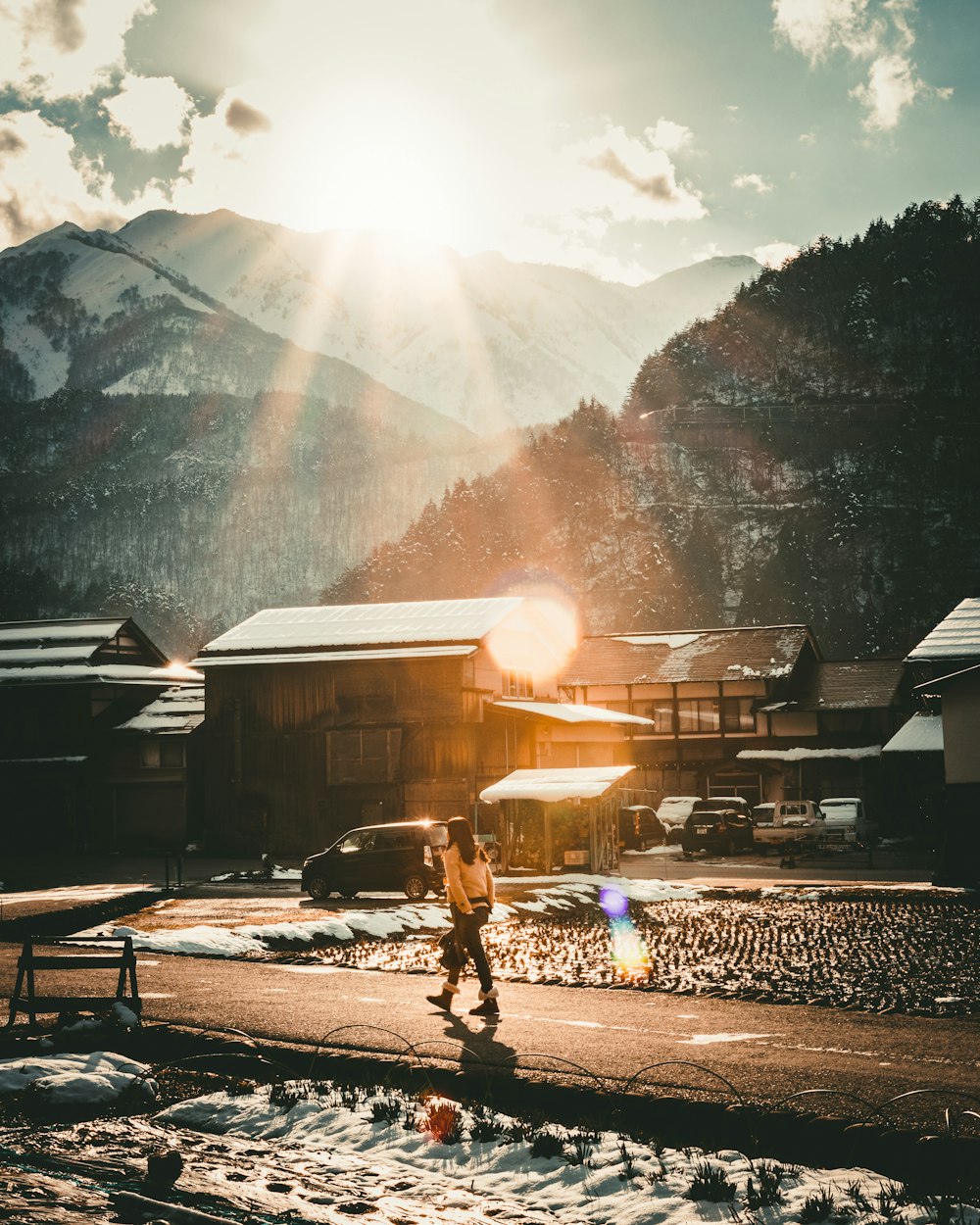 man in black jacket walking on road during daytime