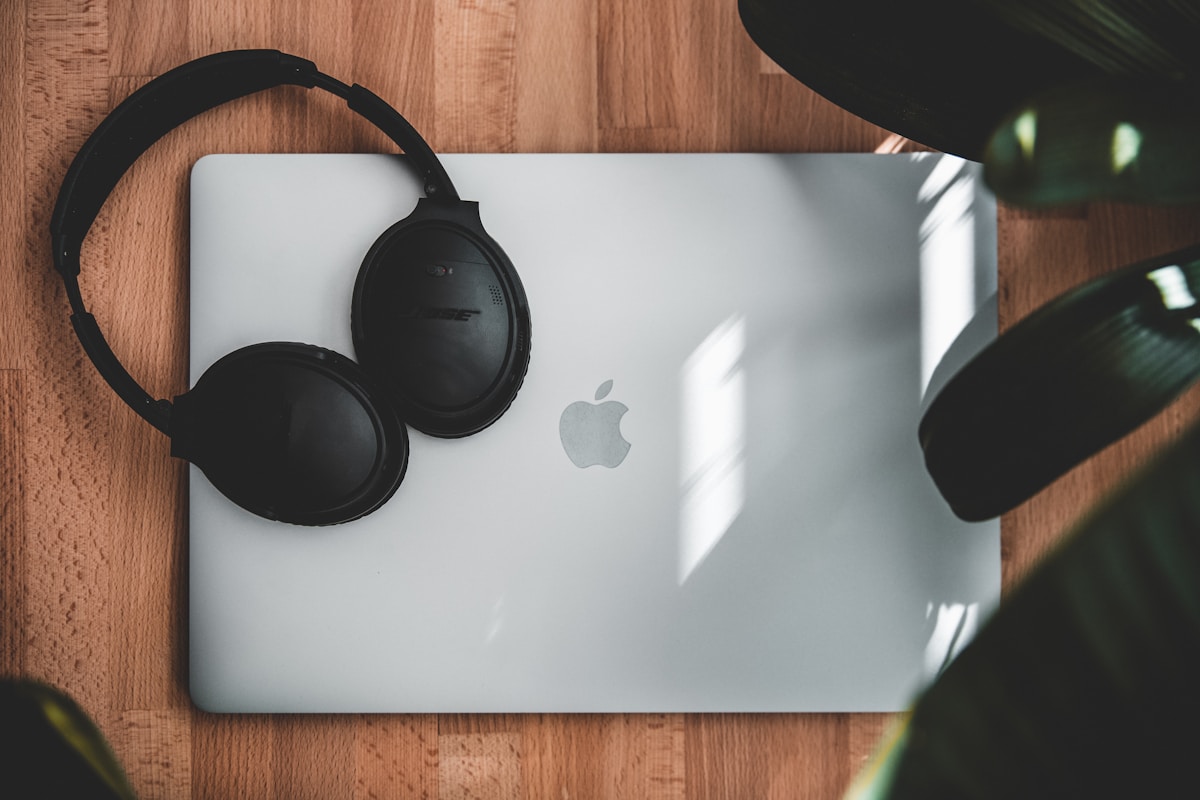 Black headphones on silver macbook