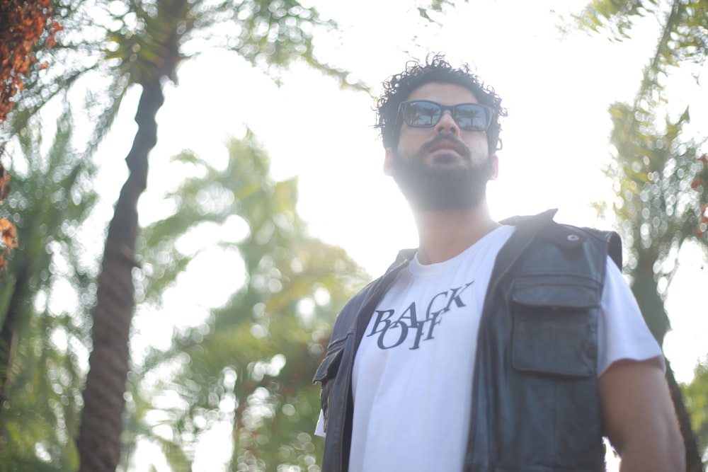 man in white crew neck shirt and black backpack