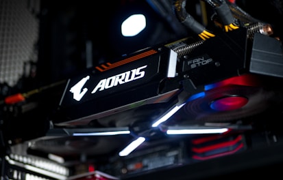 Close-up of hands upgrading a graphics card inside a gaming computer.