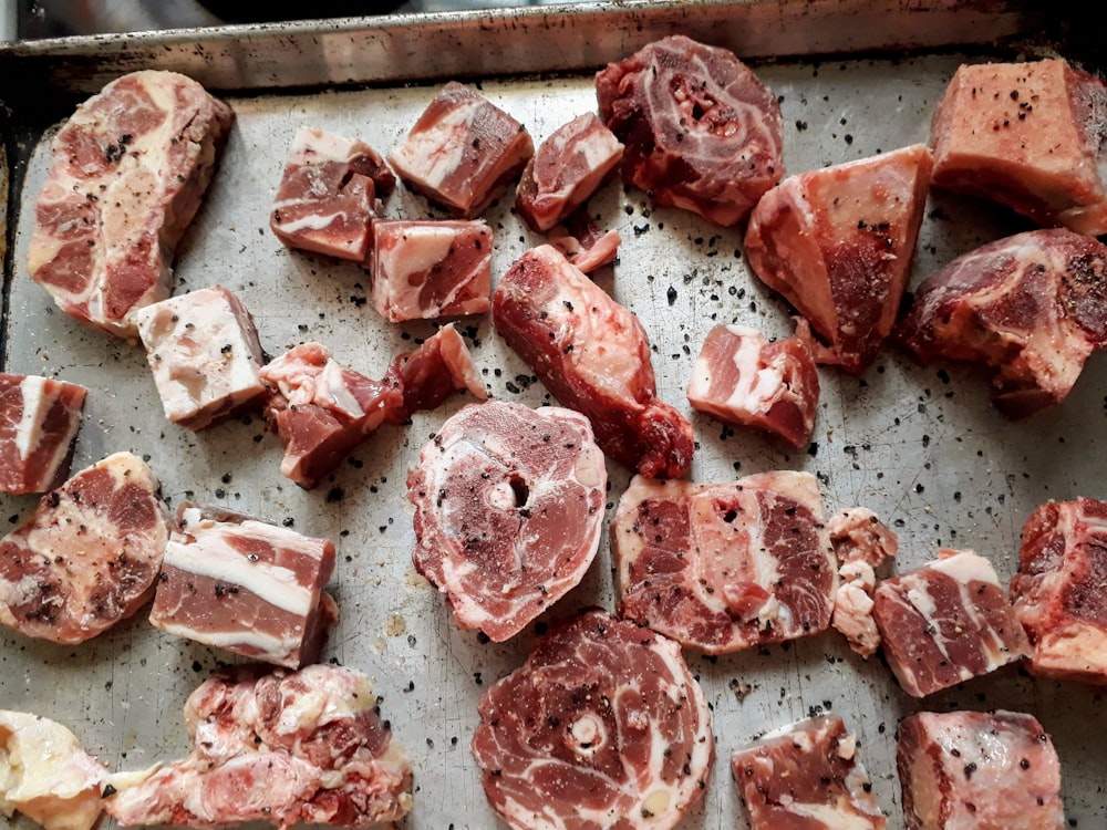 sliced raw meat on brown wooden chopping board