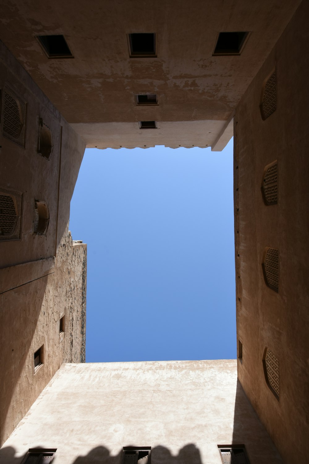 brown concrete building under blue sky during daytime