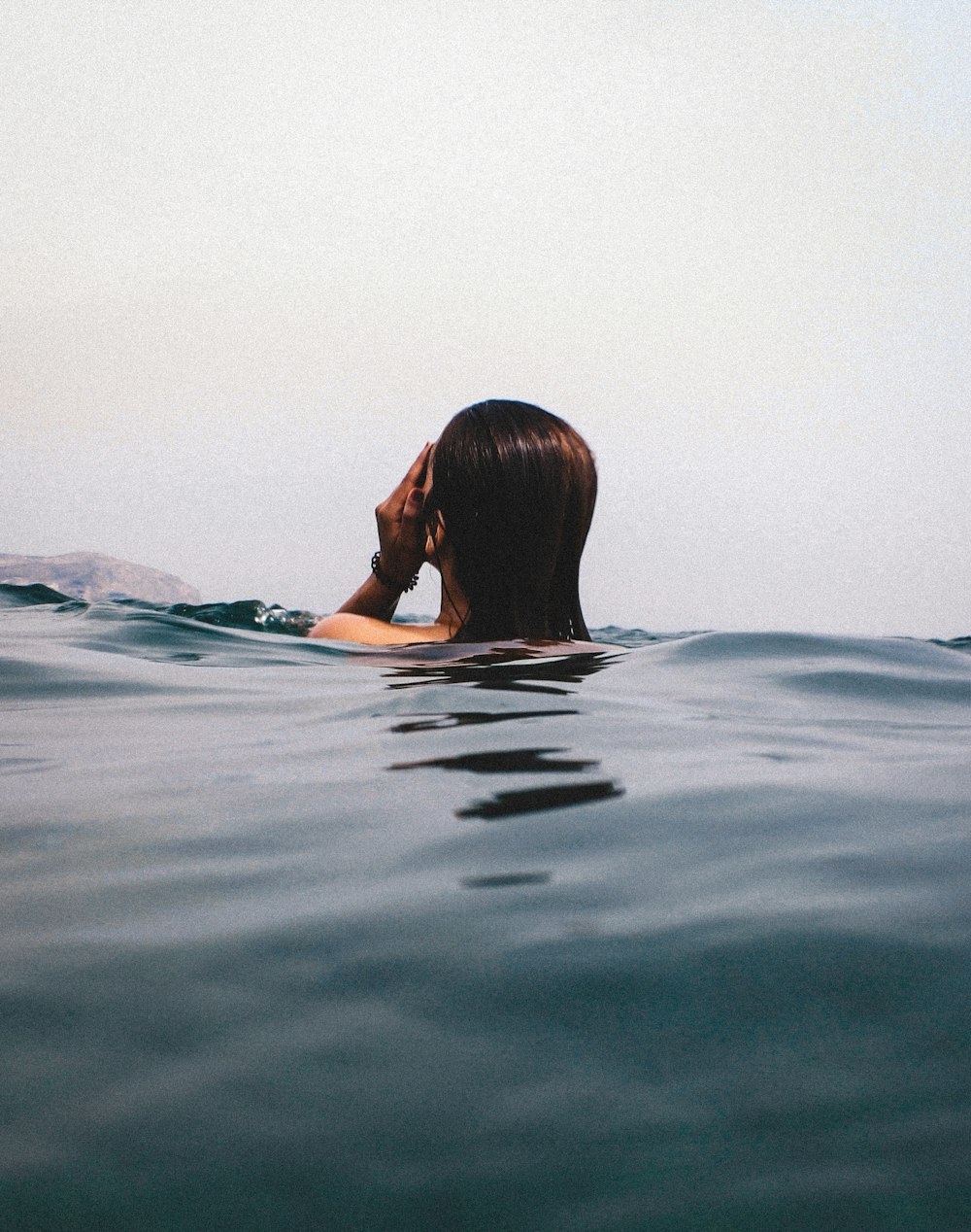 woman in blue and white bikini swimming on water