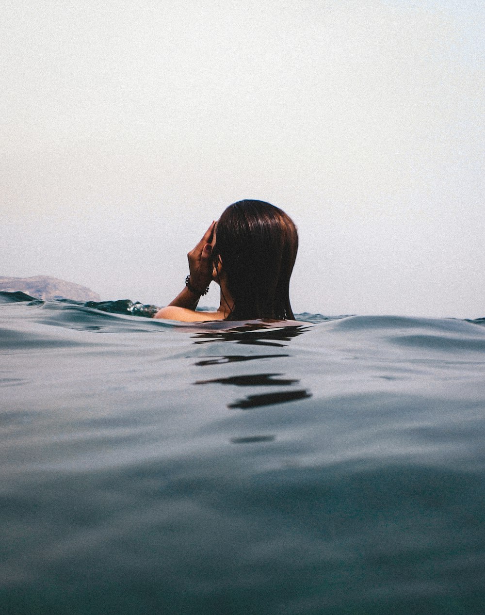 Frau im blau-weißen Bikini beim Schwimmen auf dem Wasser
