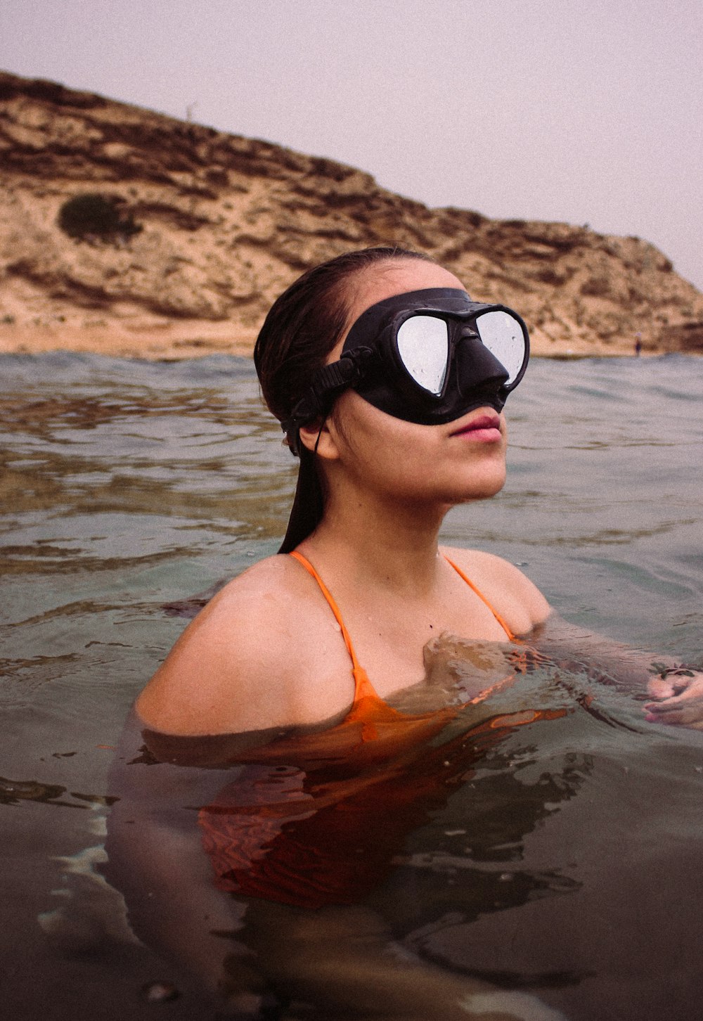 woman in black goggles in water during daytime