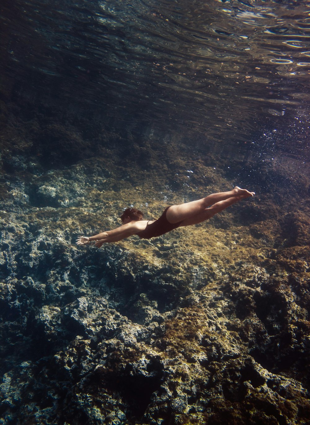 woman in blue bikini swimming in water