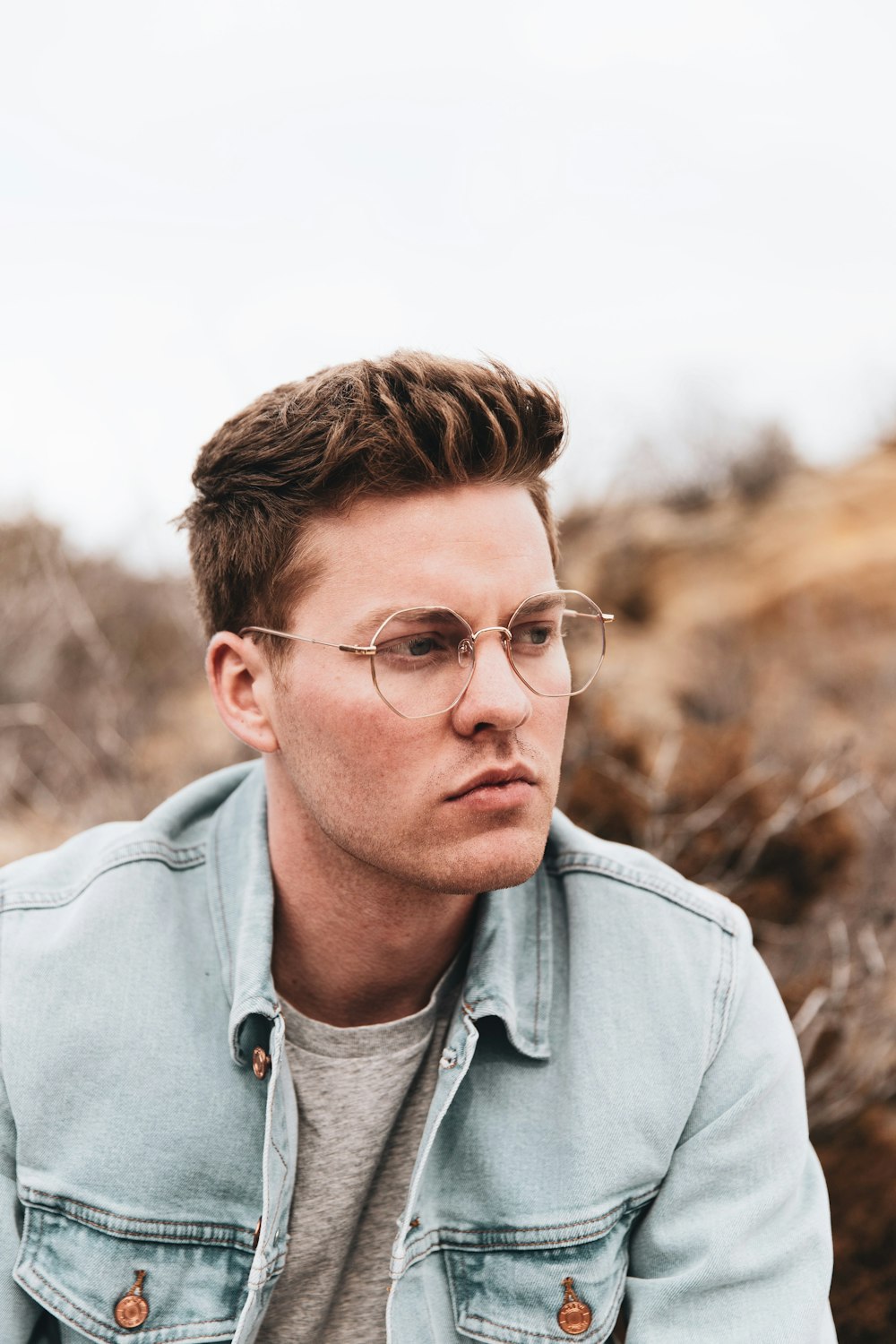 man in gray collared shirt wearing eyeglasses